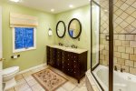 An elegant bath adjoining the owners suite has a double vanity, shower and jacuzzi tub. 
